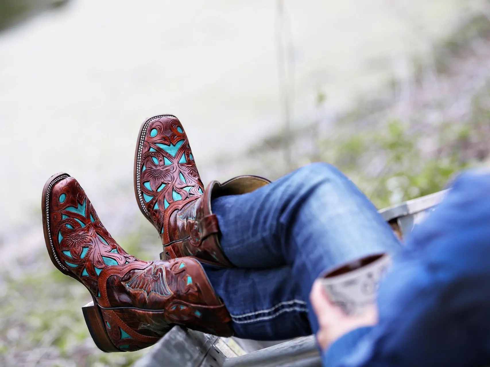 woman in cowboy boots with her feet up