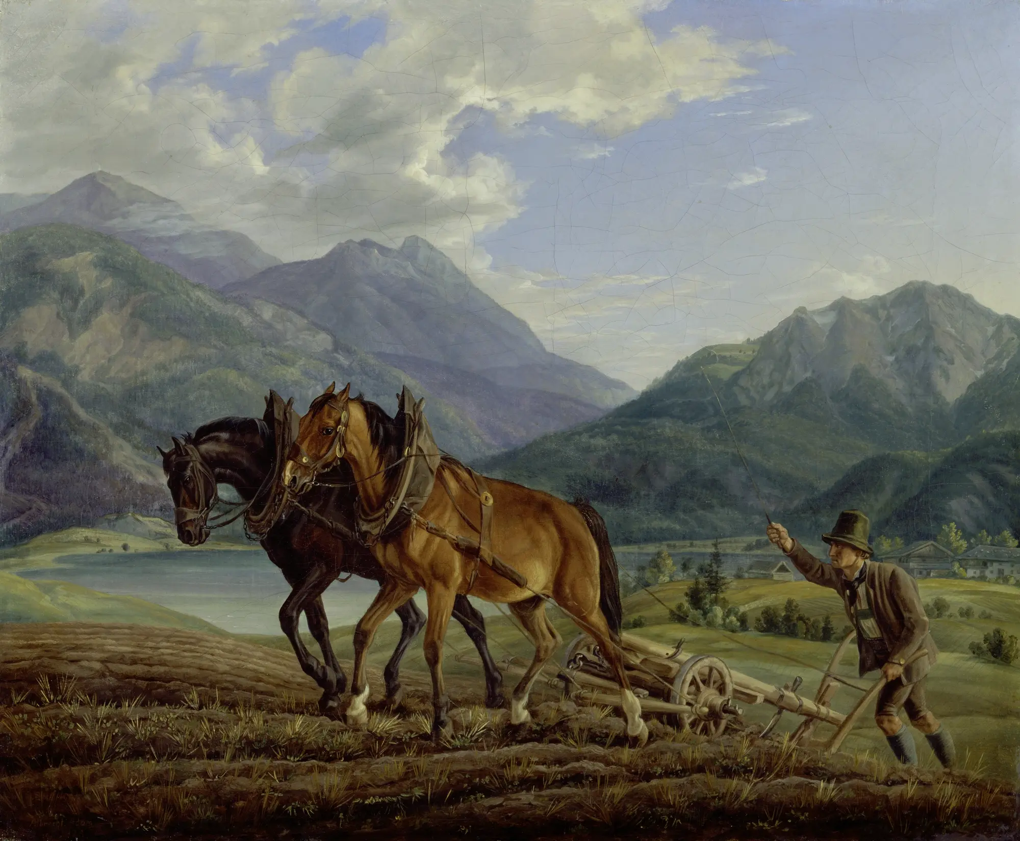 Mountain landscape with ploughing farmer