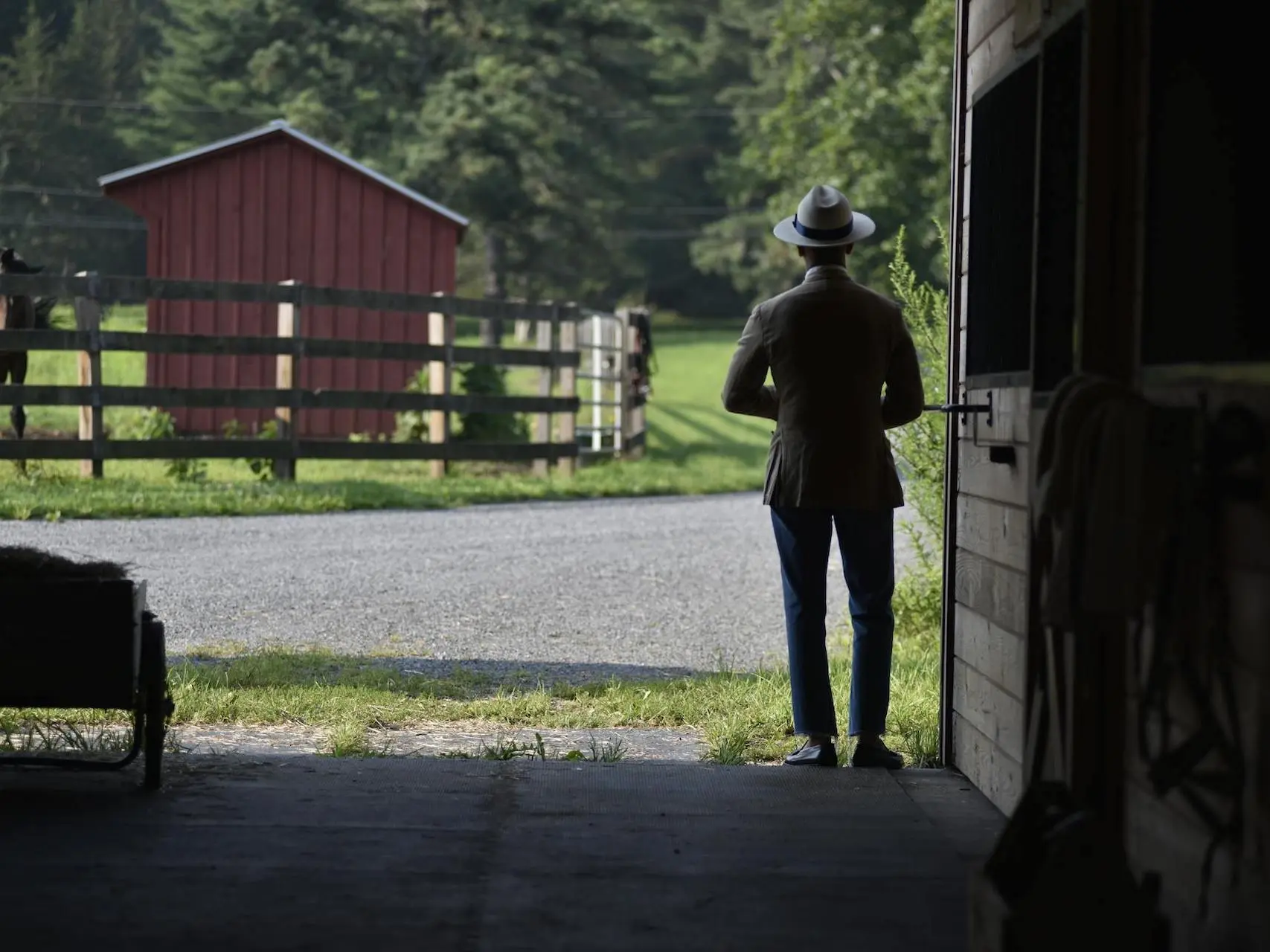 Man in a suit standing in a barn