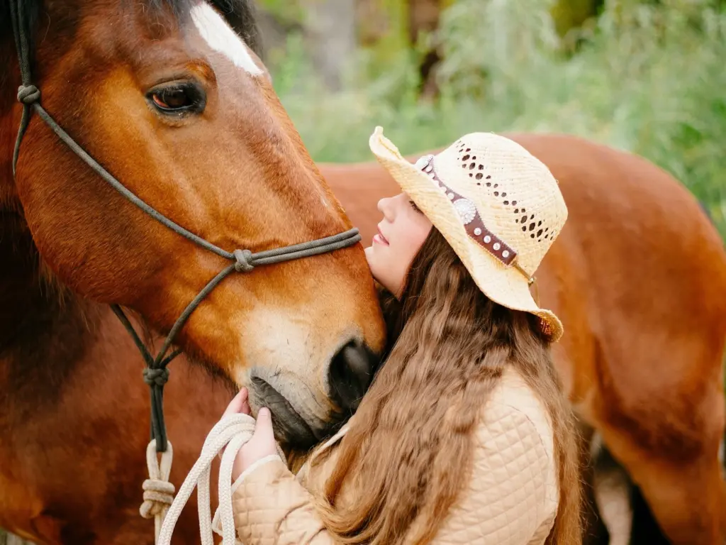 Woman cuddling her horse