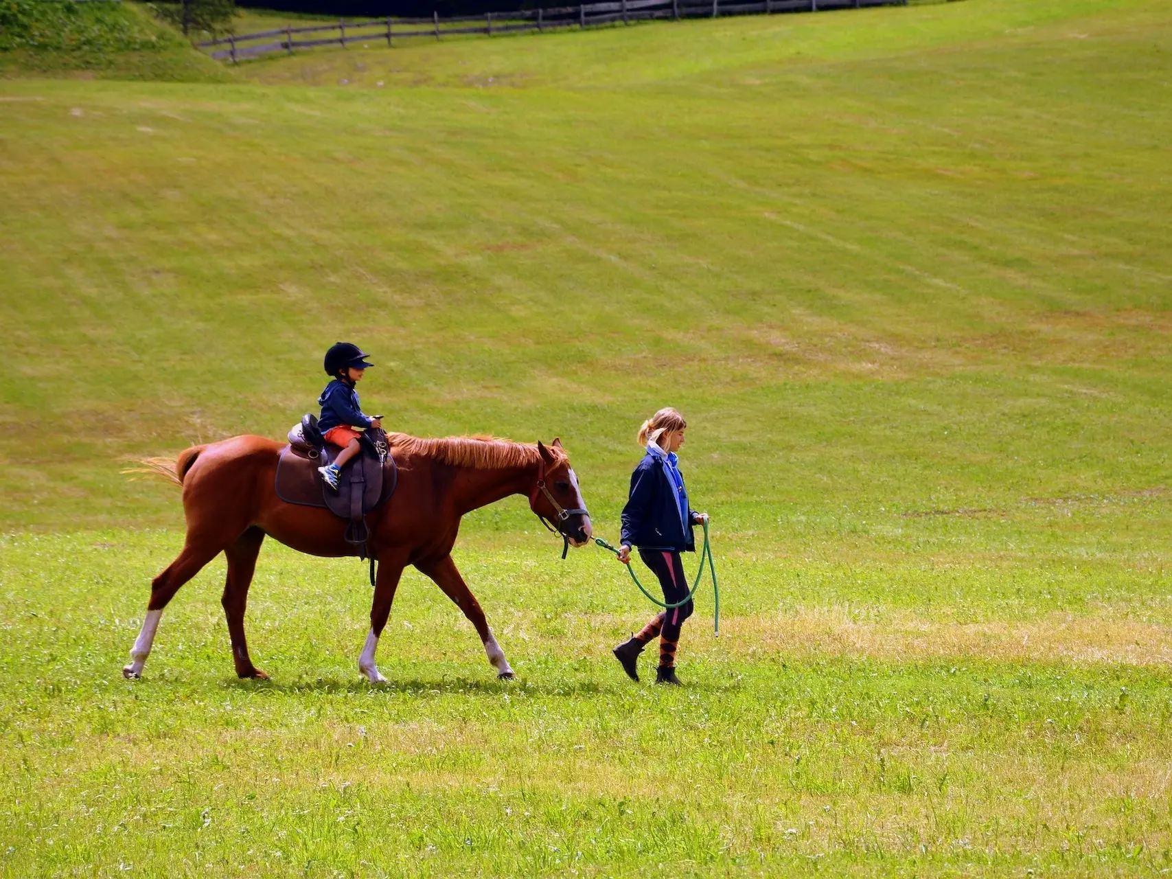 Woman leading a child on a pony