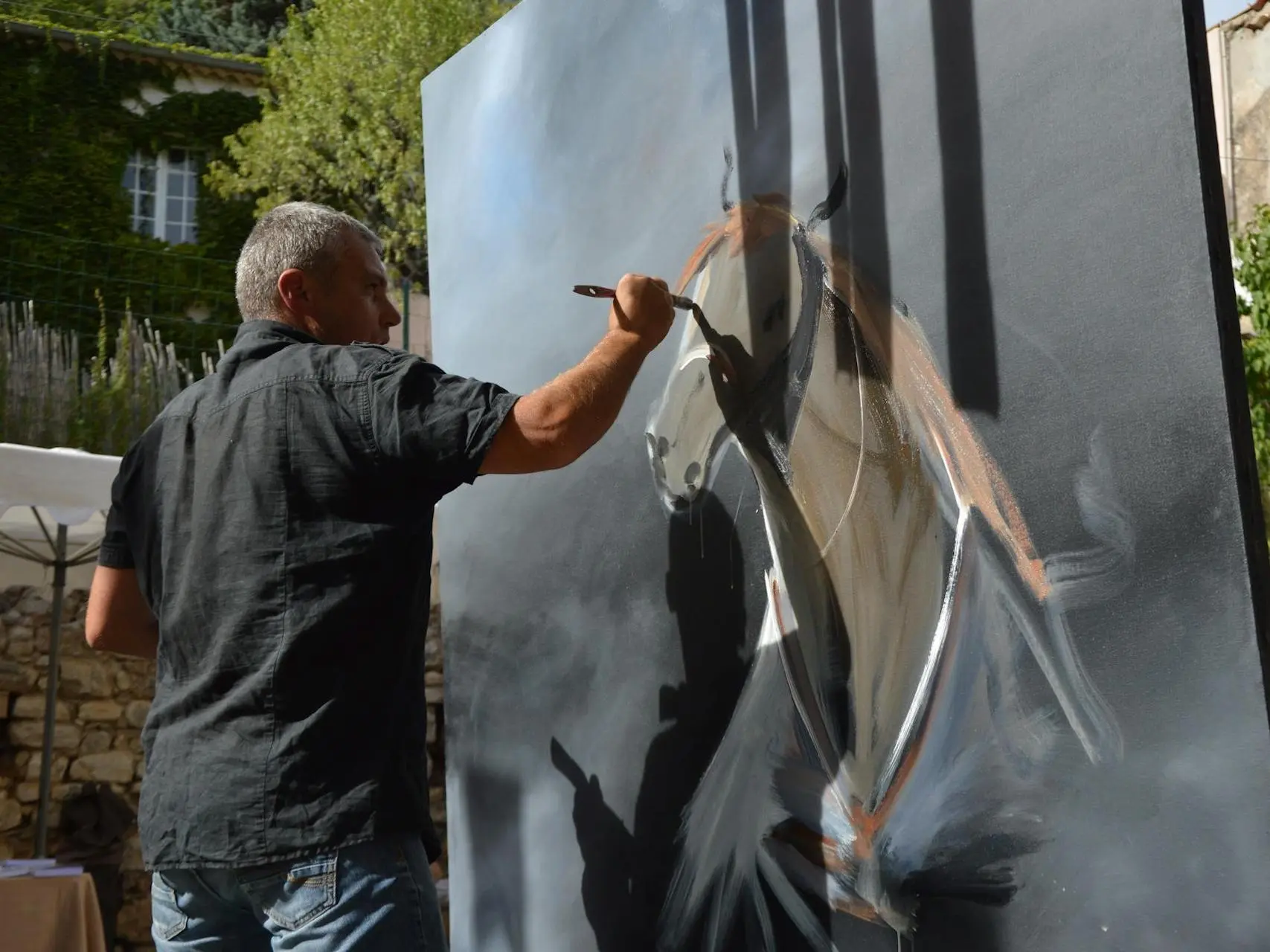 Man painting a horse