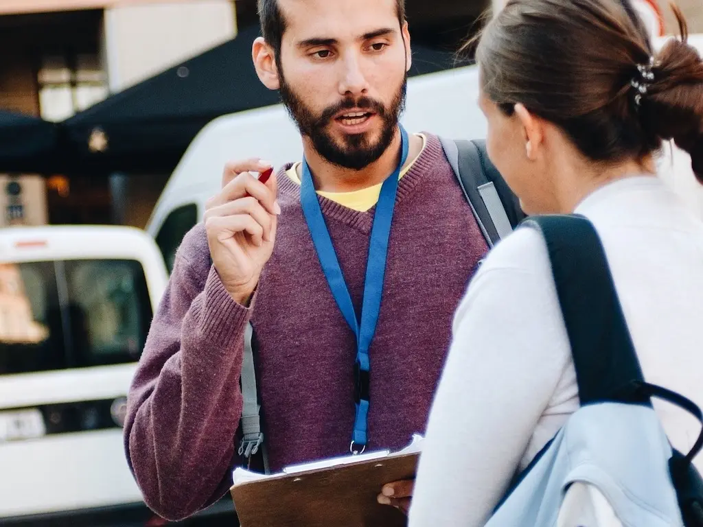 Man speaking to a woman in the street