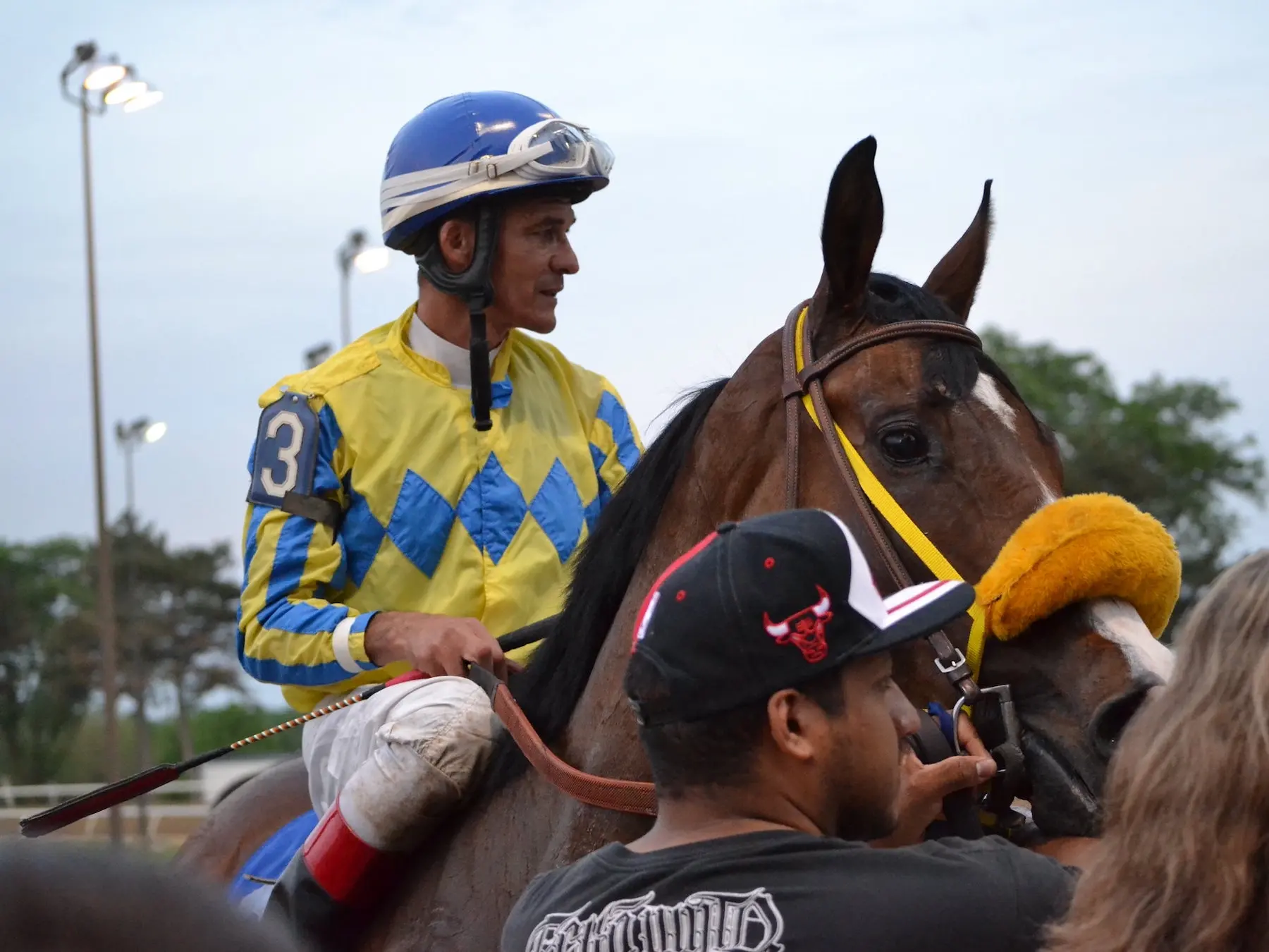 Jockey on a horse surrounded by people