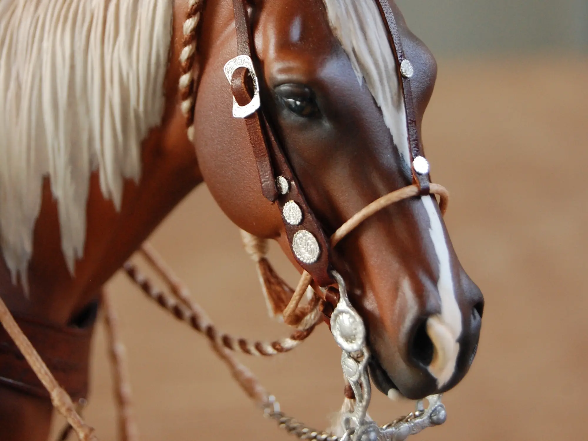 Model horse wearing miniature handmade bridle