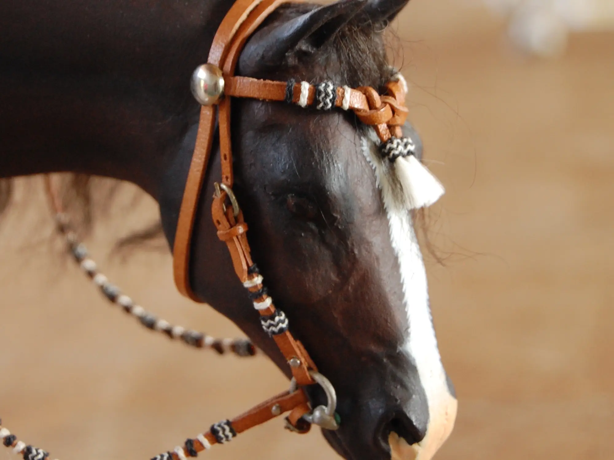 Model horse wearing miniature handmade bridle