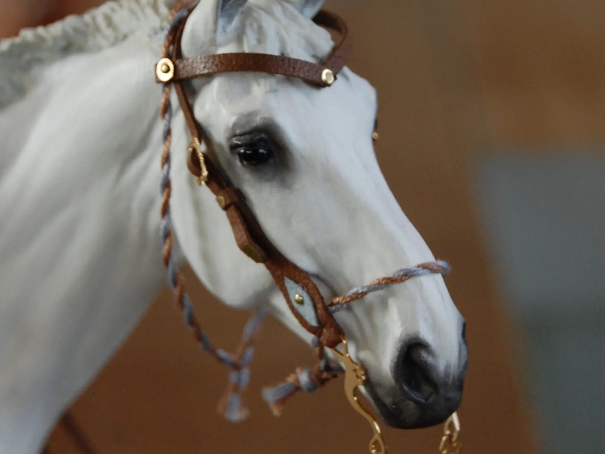 Model horse wearing miniature handmade bridle