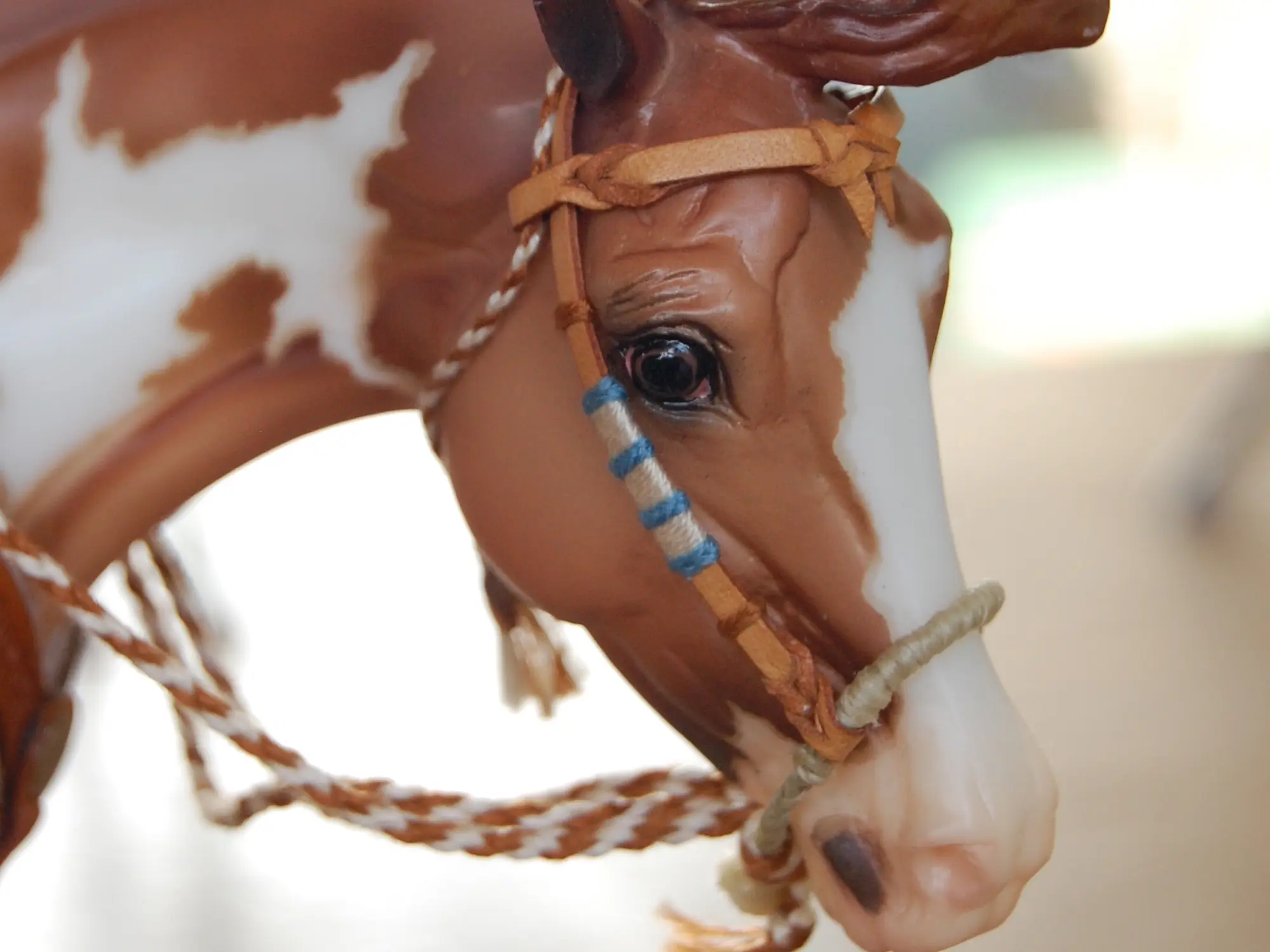 Model horse wearing miniature handmade bridle