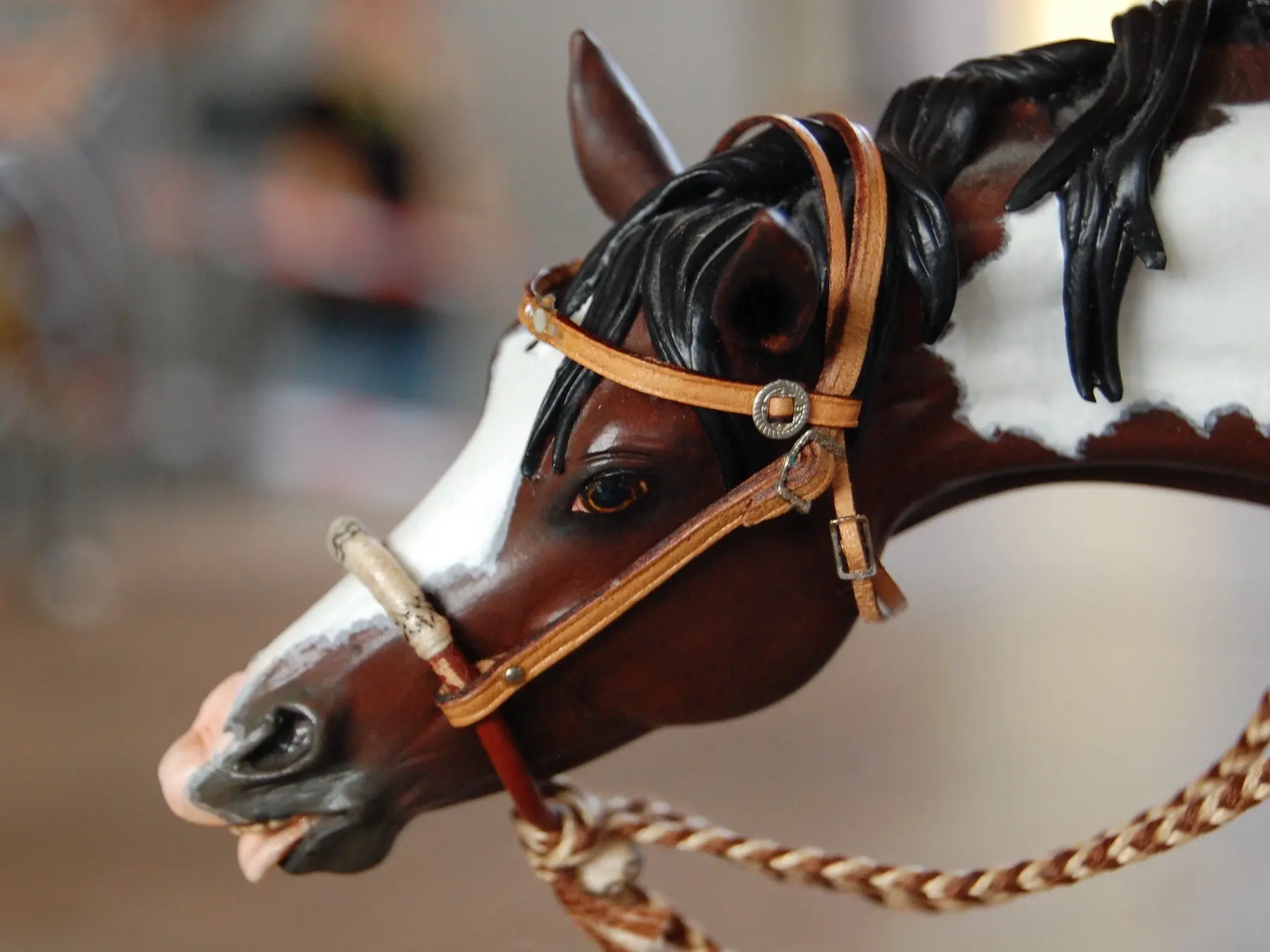 Model horse wearing miniature handmade bridle