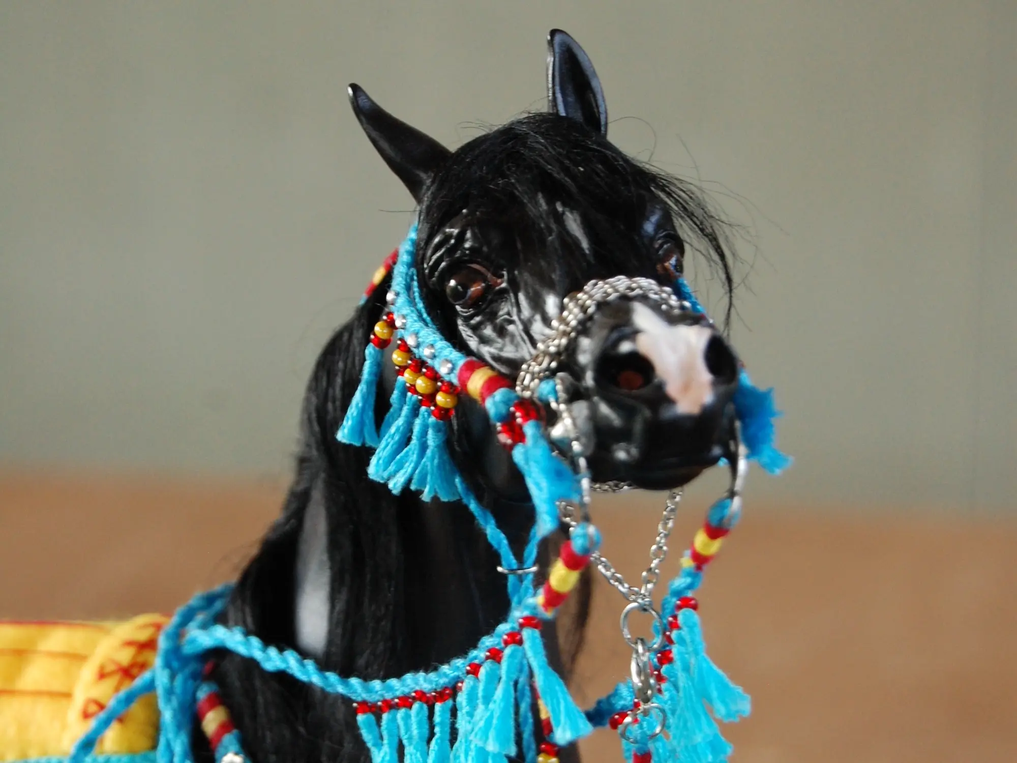 Model horse wearing miniature handmade bridle