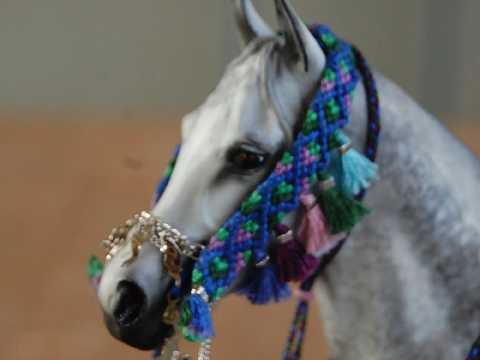 Model horse wearing miniature handmade bridle