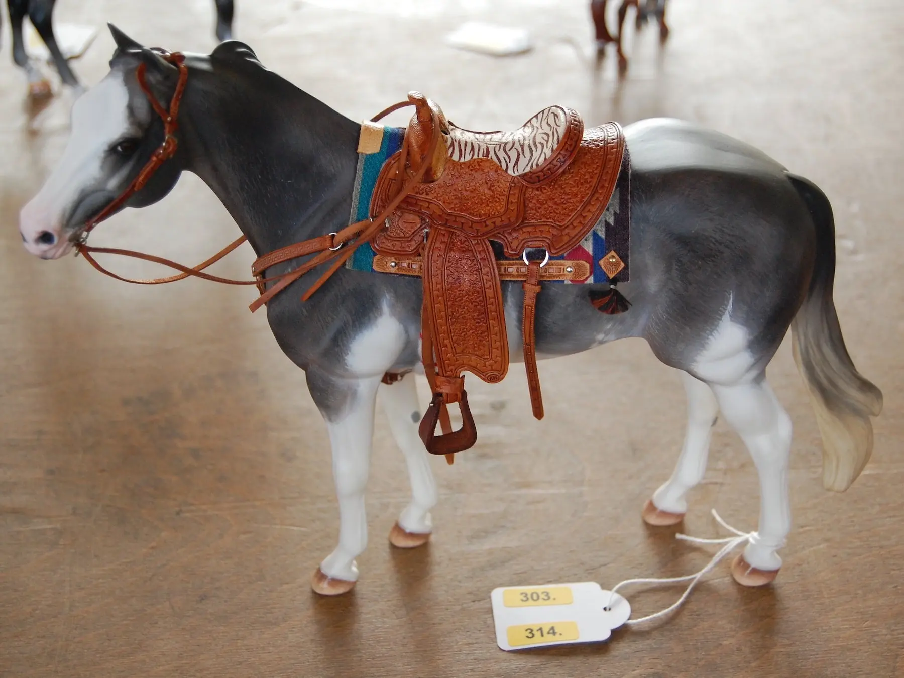 Model horse wearing miniature handmade tack