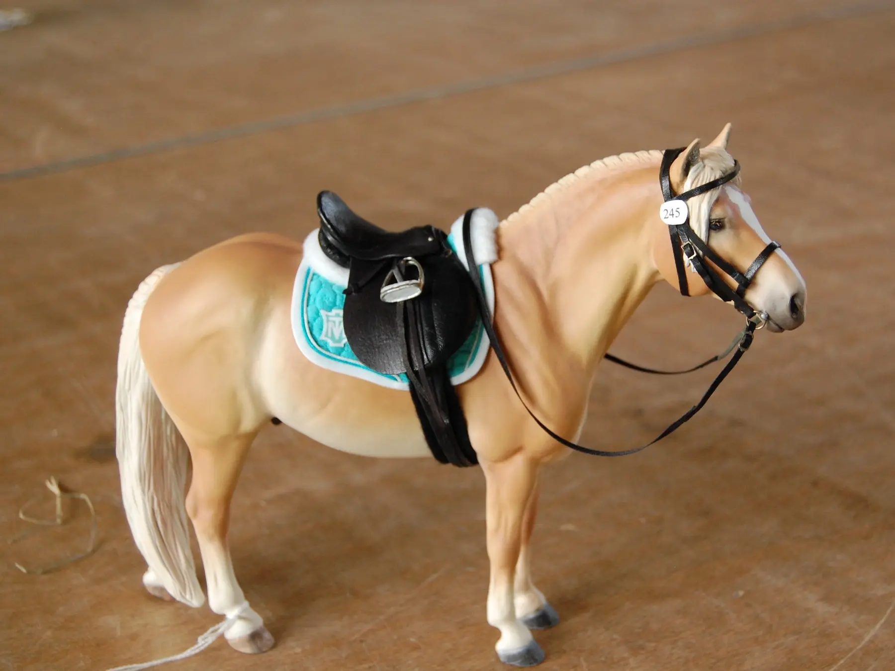 Model horse wearing miniature handmade tack