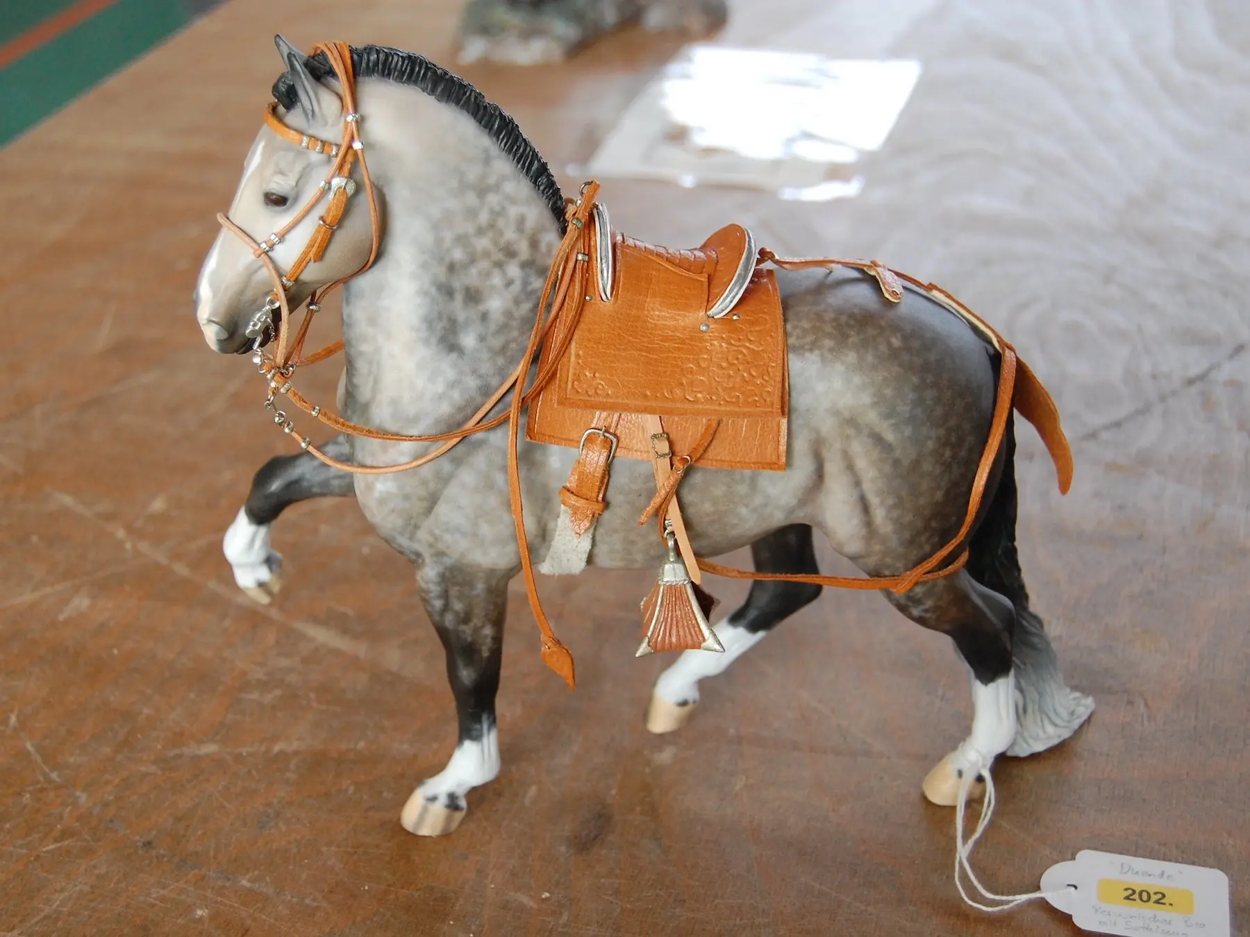 Model horse wearing miniature handmade tack