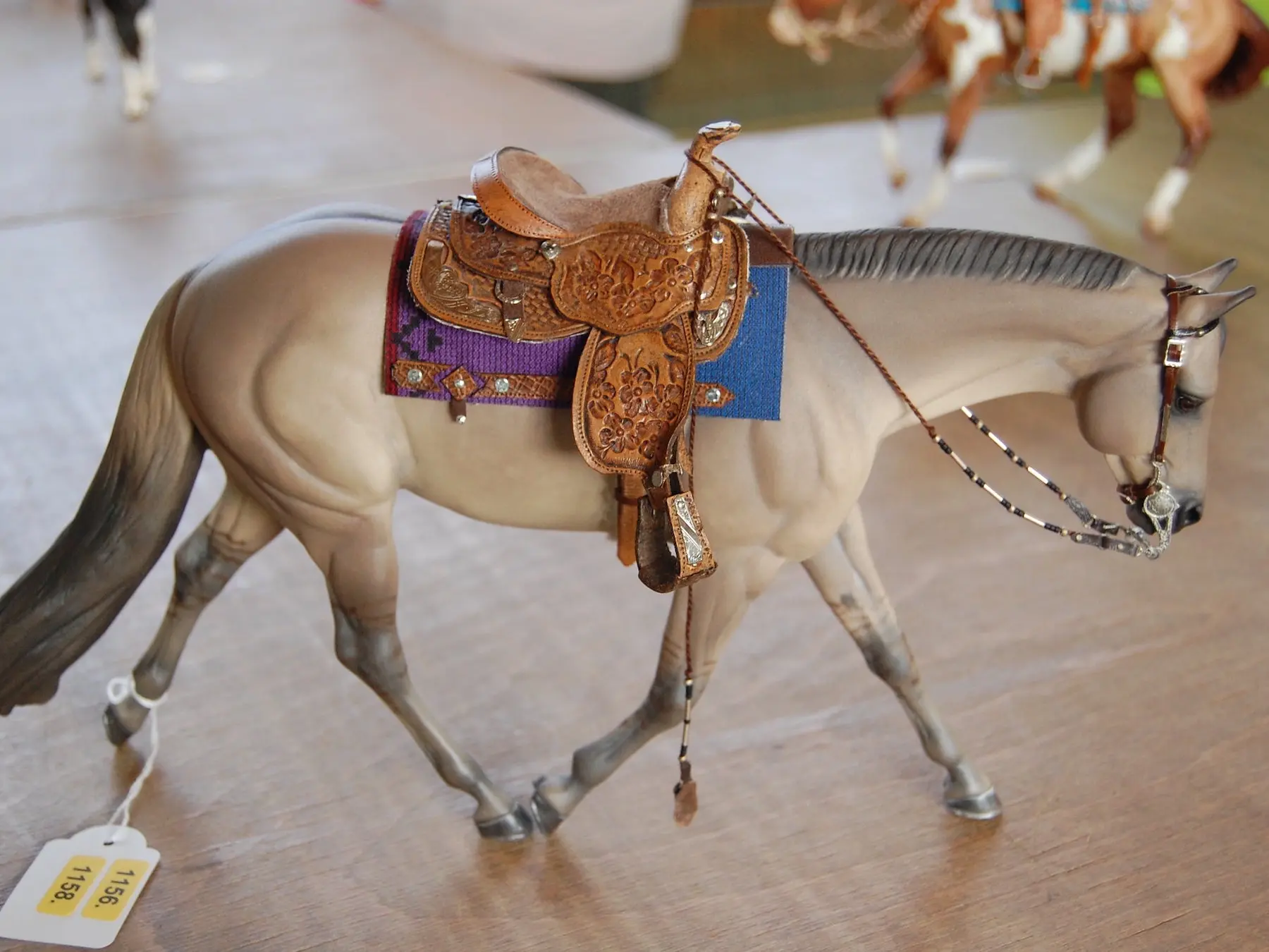 Model horse wearing miniature handmade tack