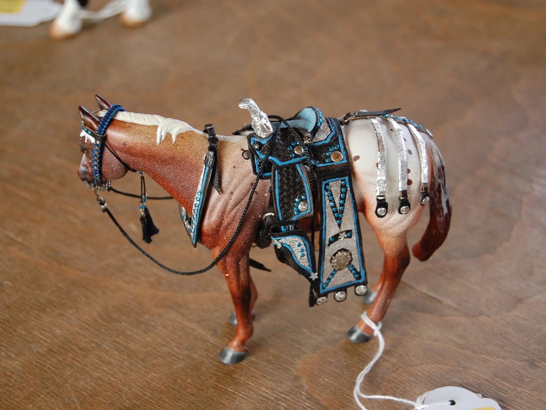 Model horse wearing miniature handmade tack