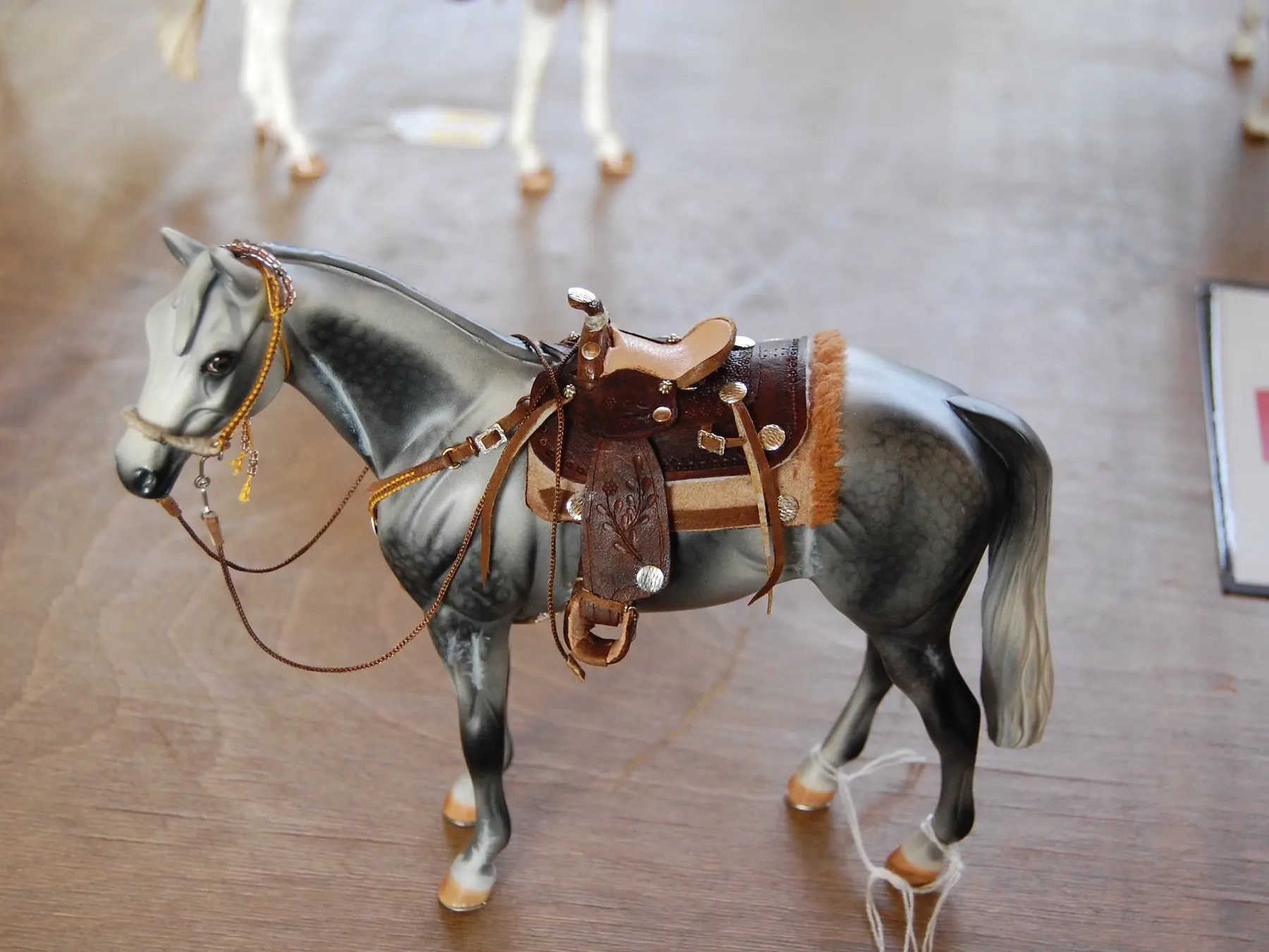 Model horse wearing miniature handmade tack