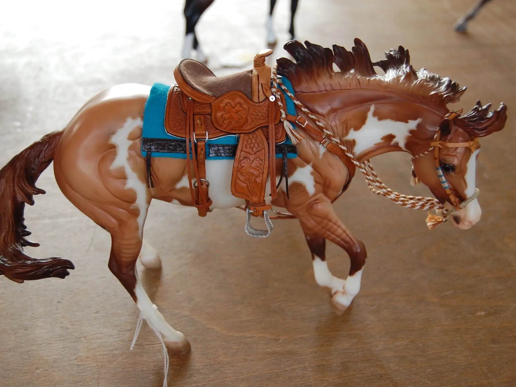 Model horse wearing miniature handmade tack