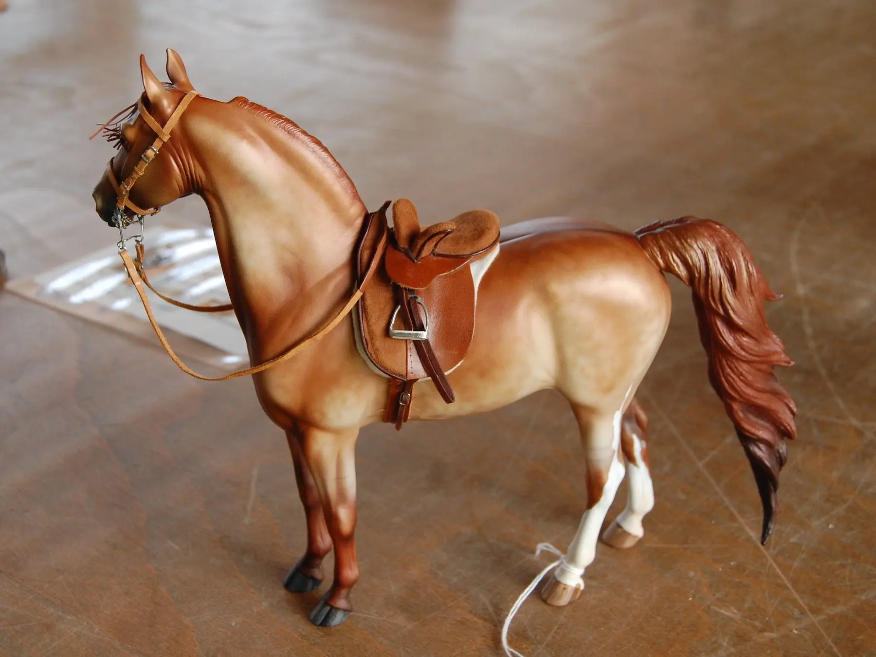 Model horse wearing miniature handmade tack