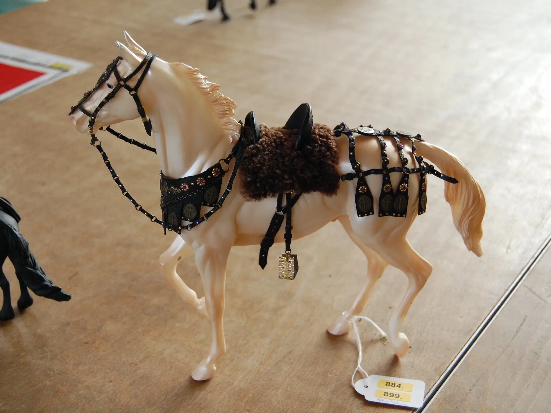 Model horse wearing miniature handmade tack