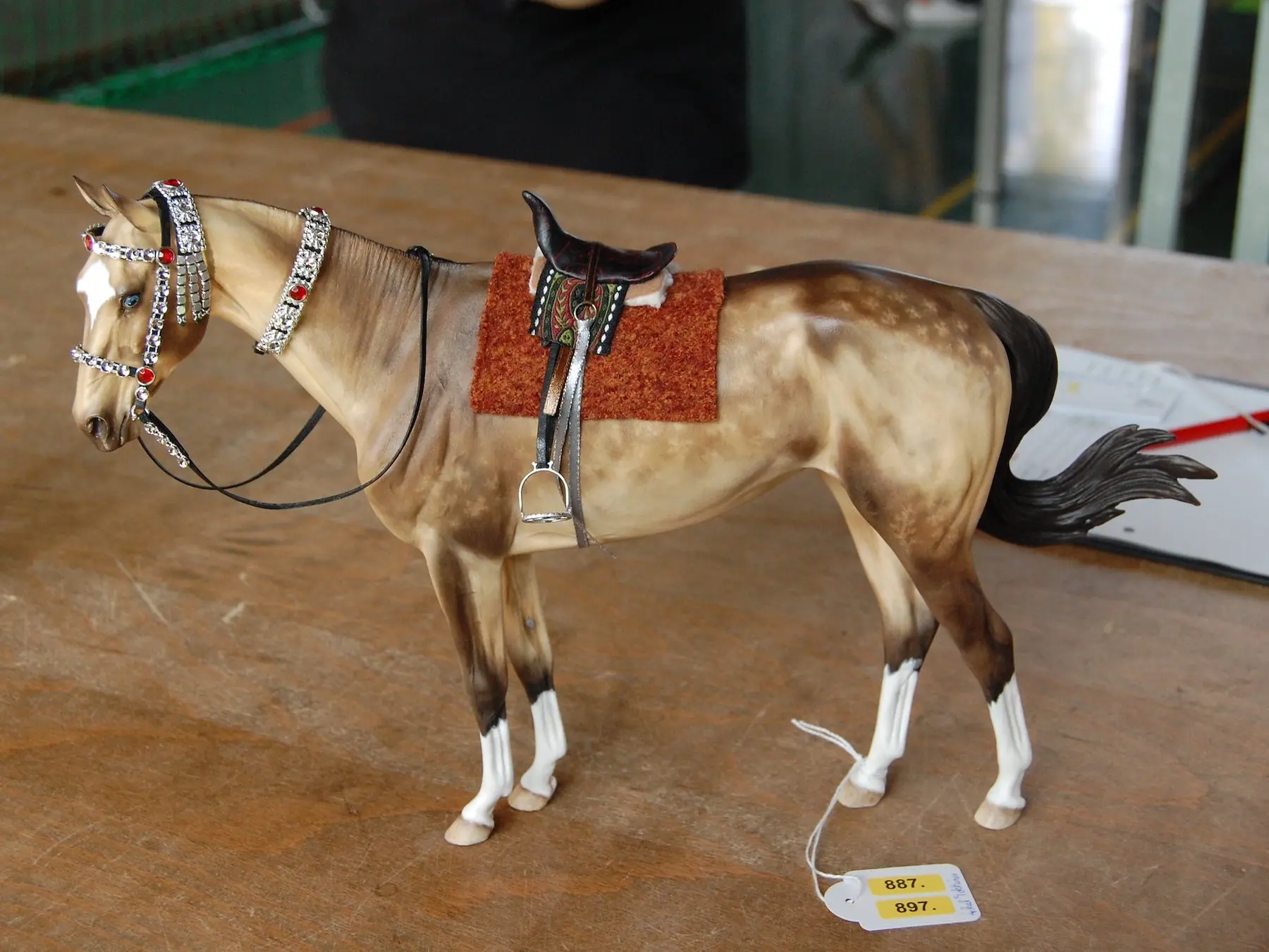 Model horse wearing miniature handmade tack