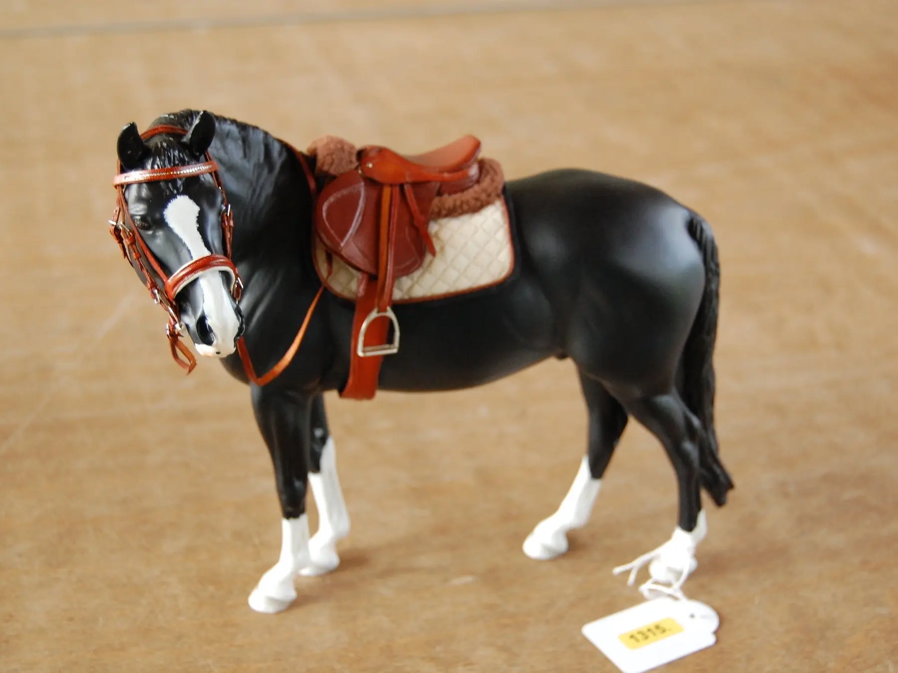 Model horse wearing miniature handmade tack