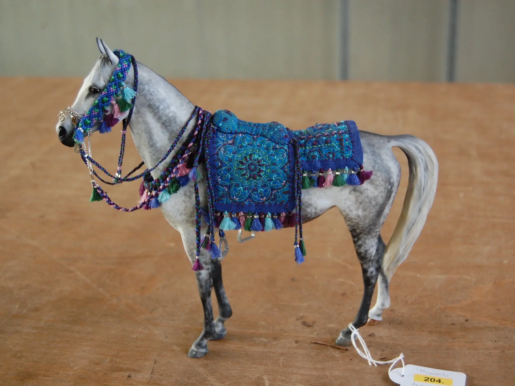 Model horse wearing miniature handmade tack