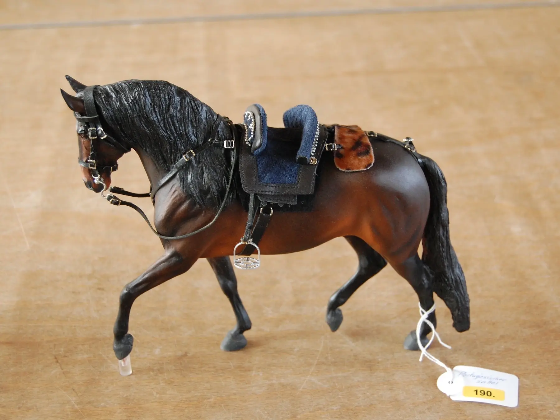 Model horse wearing miniature handmade tack