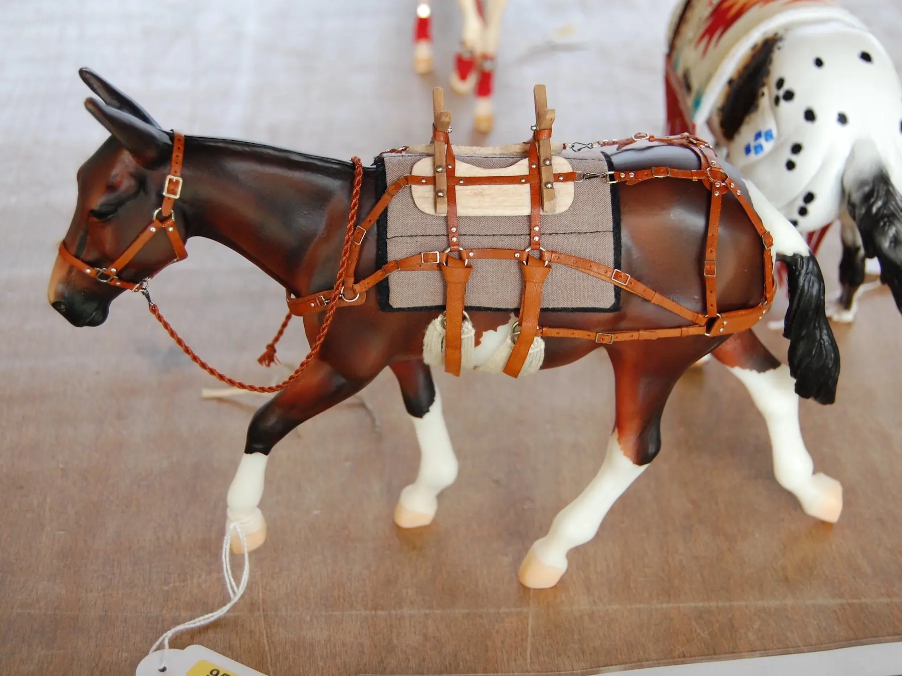 Model horse wearing miniature handmade tack