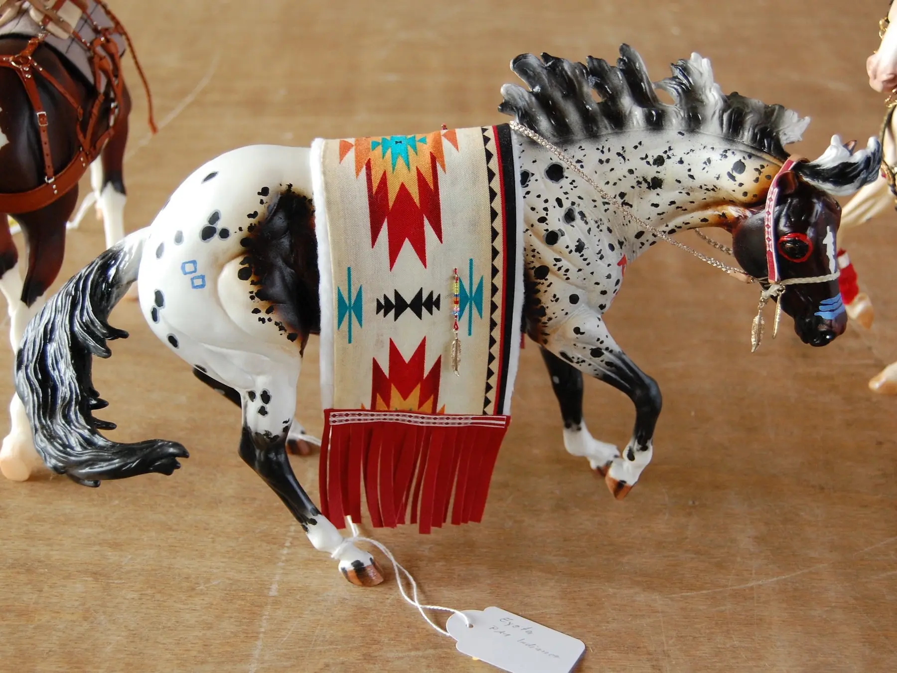 Model horse wearing miniature handmade tack