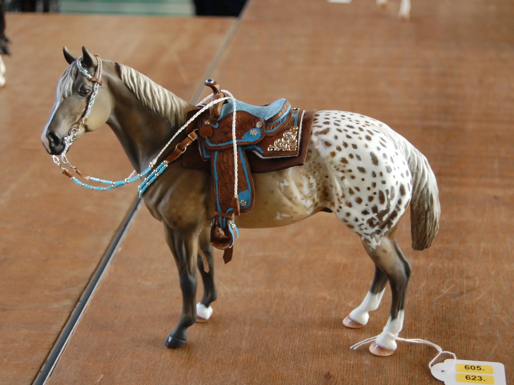 Model horse wearing miniature handmade tack