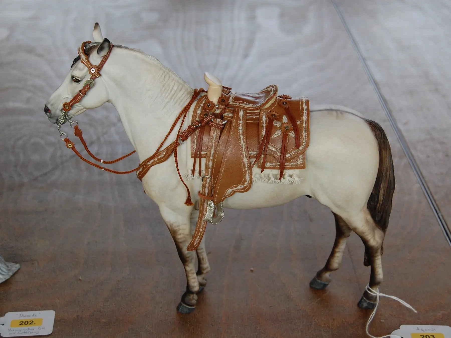 Model horse wearing miniature handmade tack