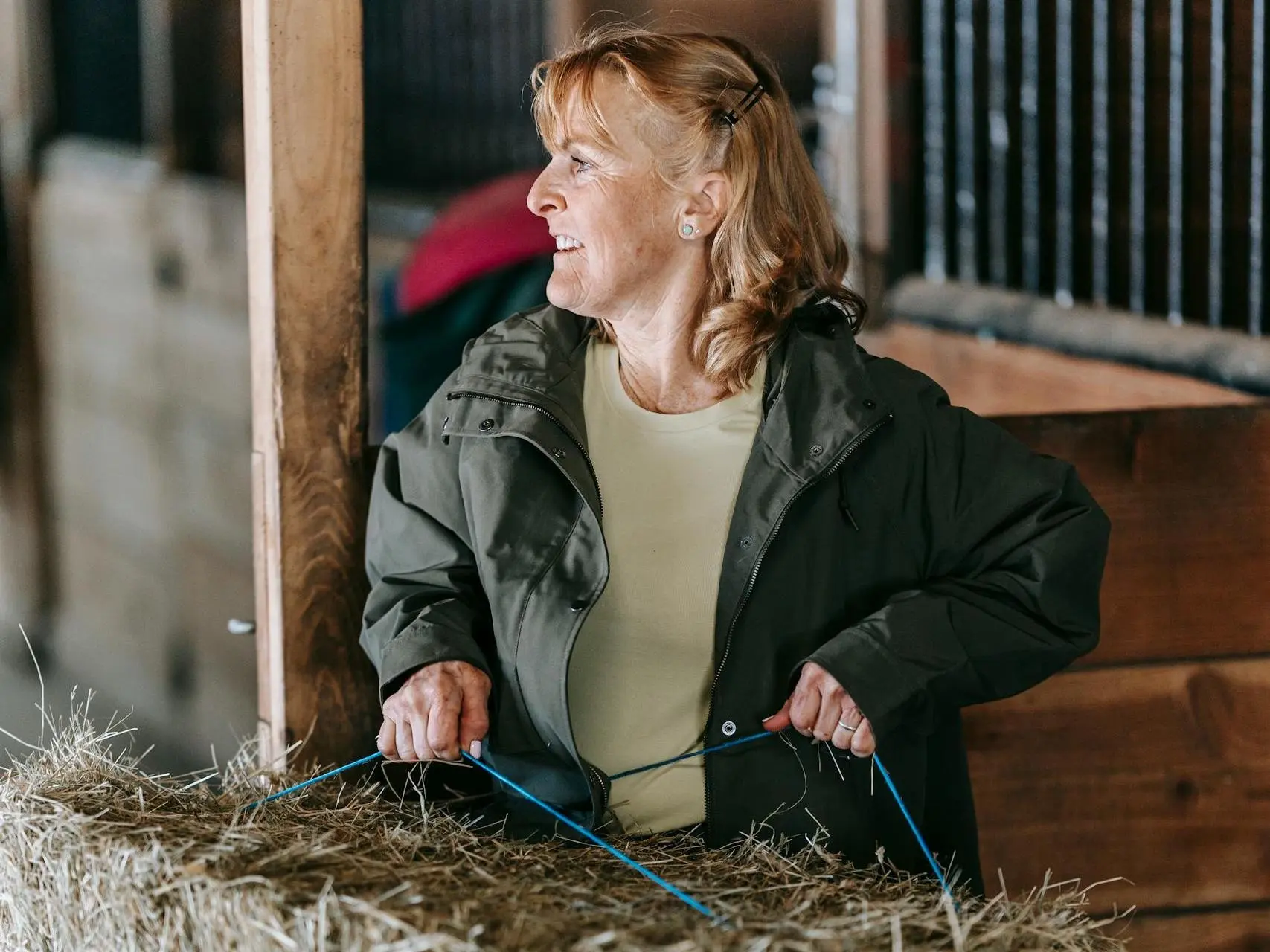 Woman carrying a bale of hay