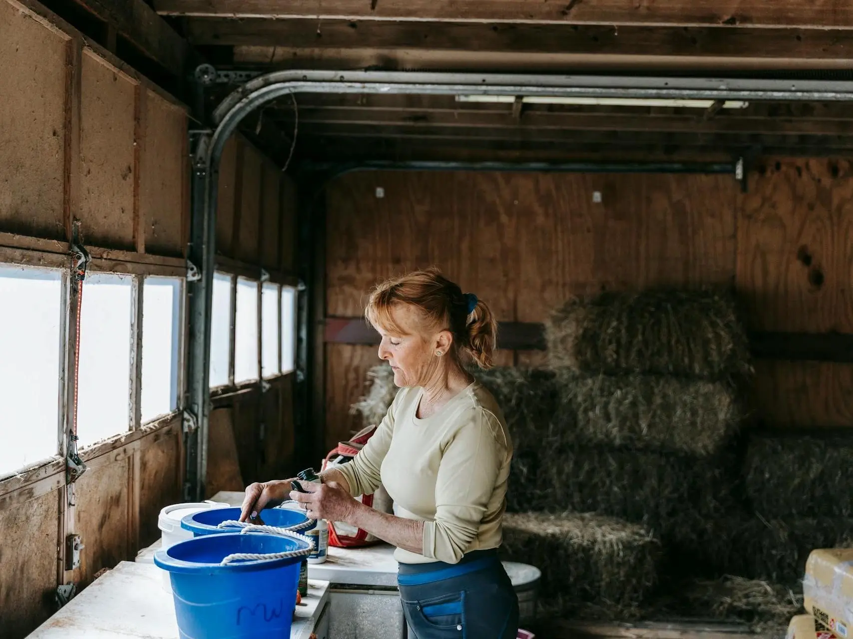 Woman measuring powder in a feed room