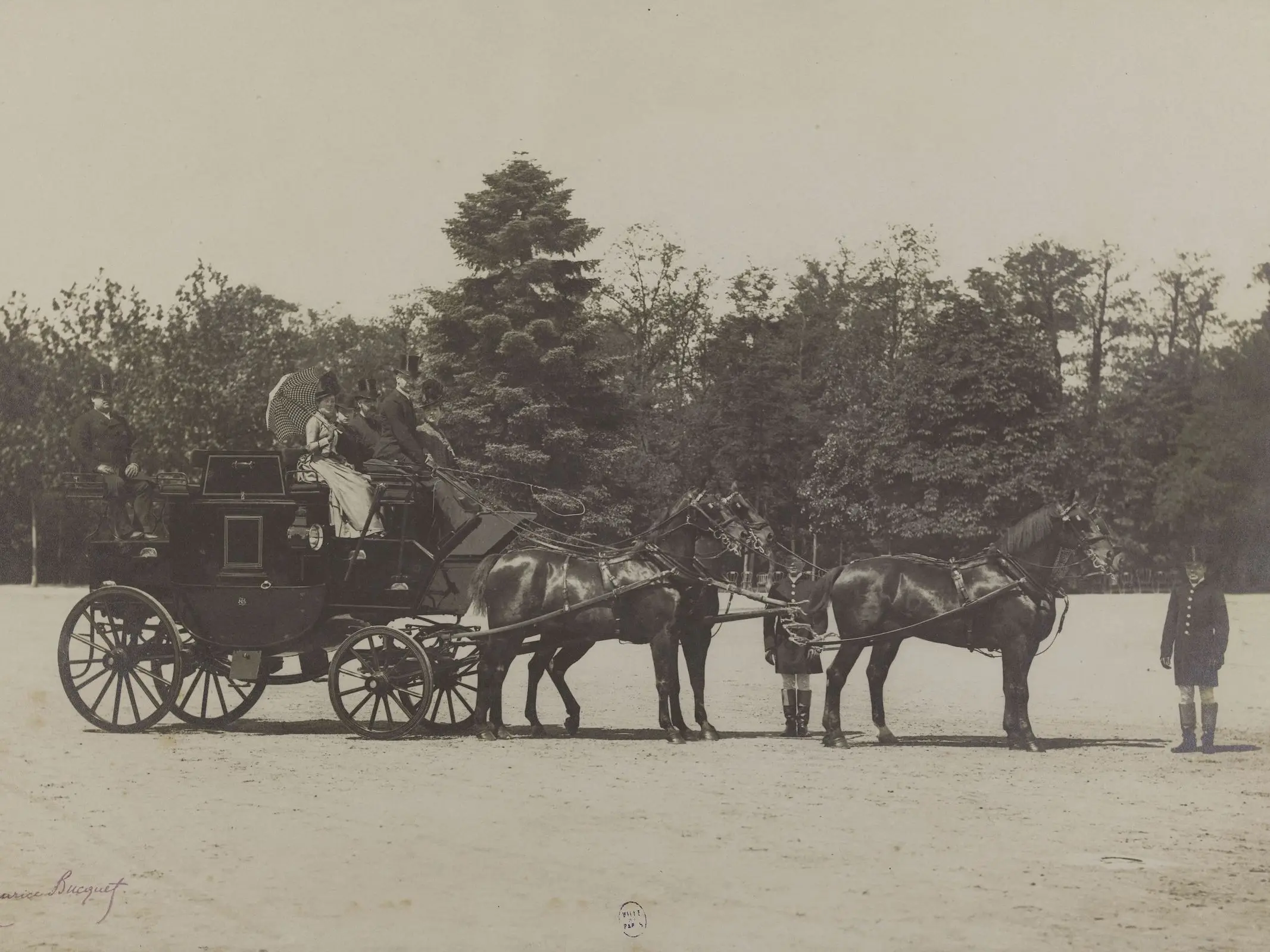 A team of four horses and a black carriage