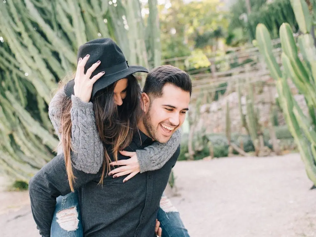 Woman riding piggyback on a mans back