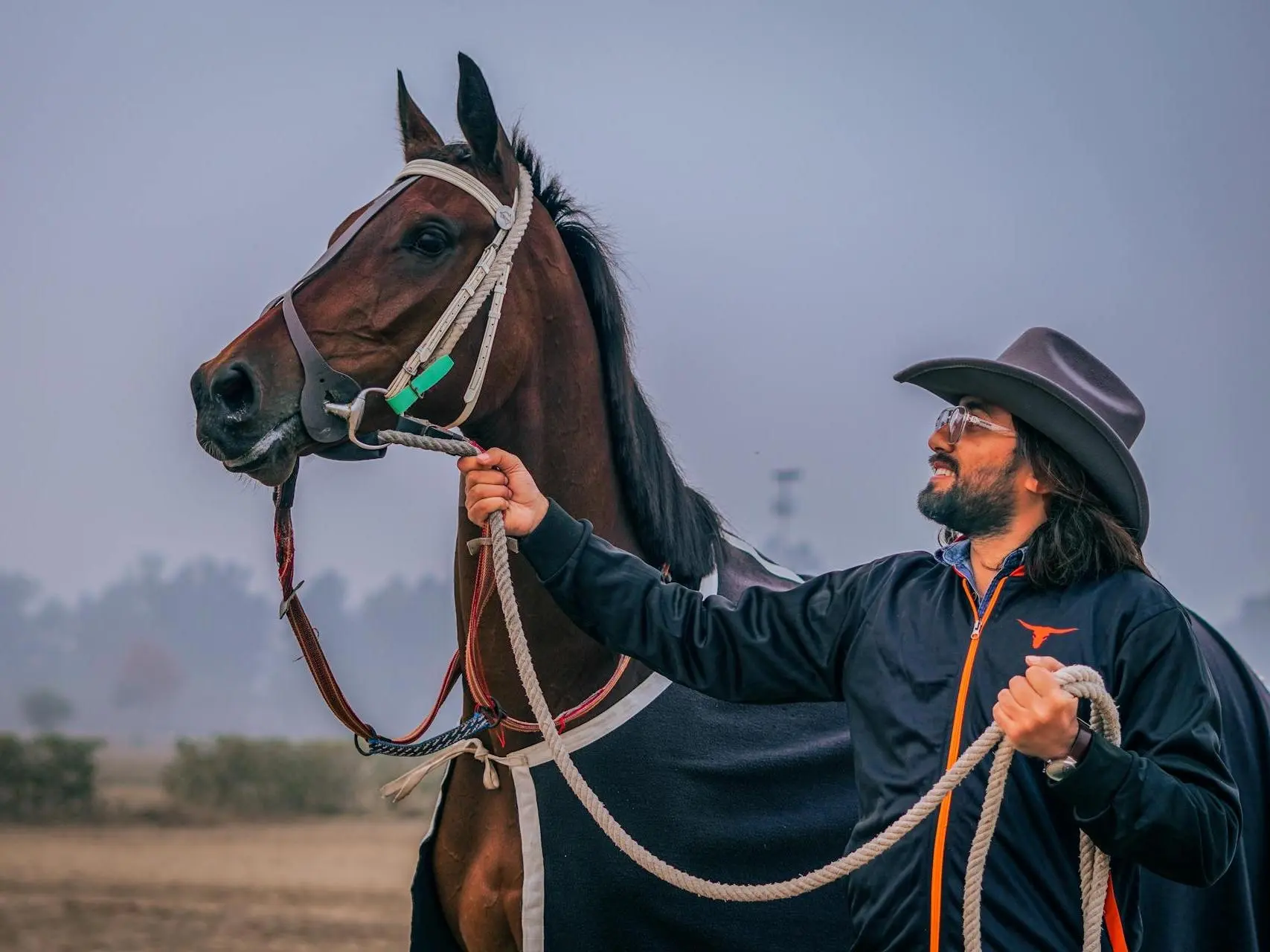 Man holding a spirited racehorse