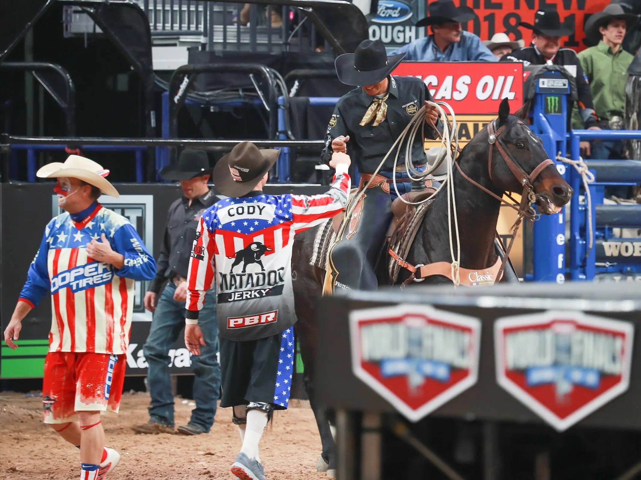 Rodeo clowns standing in a corral