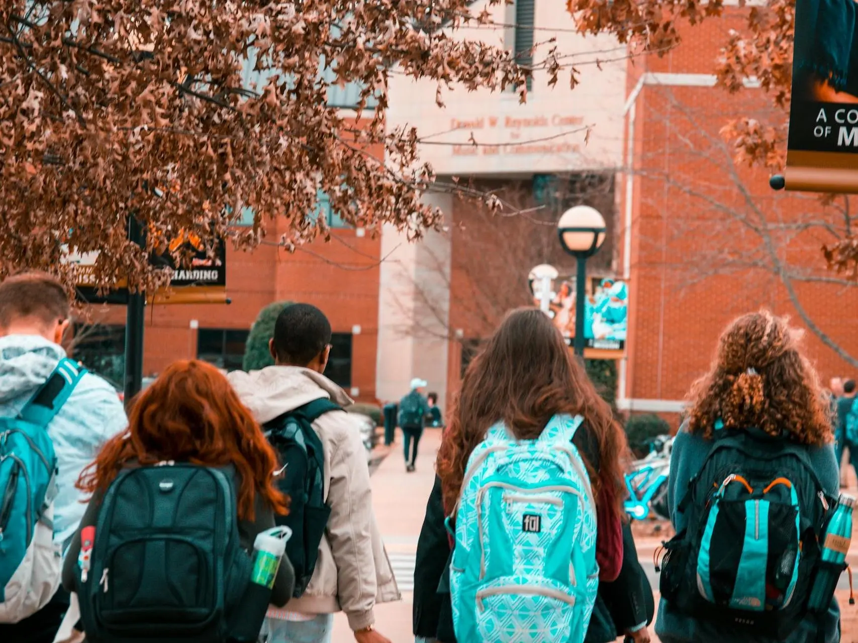 Young people walking towards a school