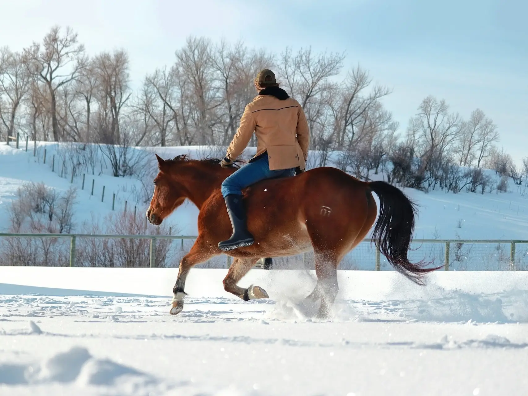 Man riding a horse bareback in the snow