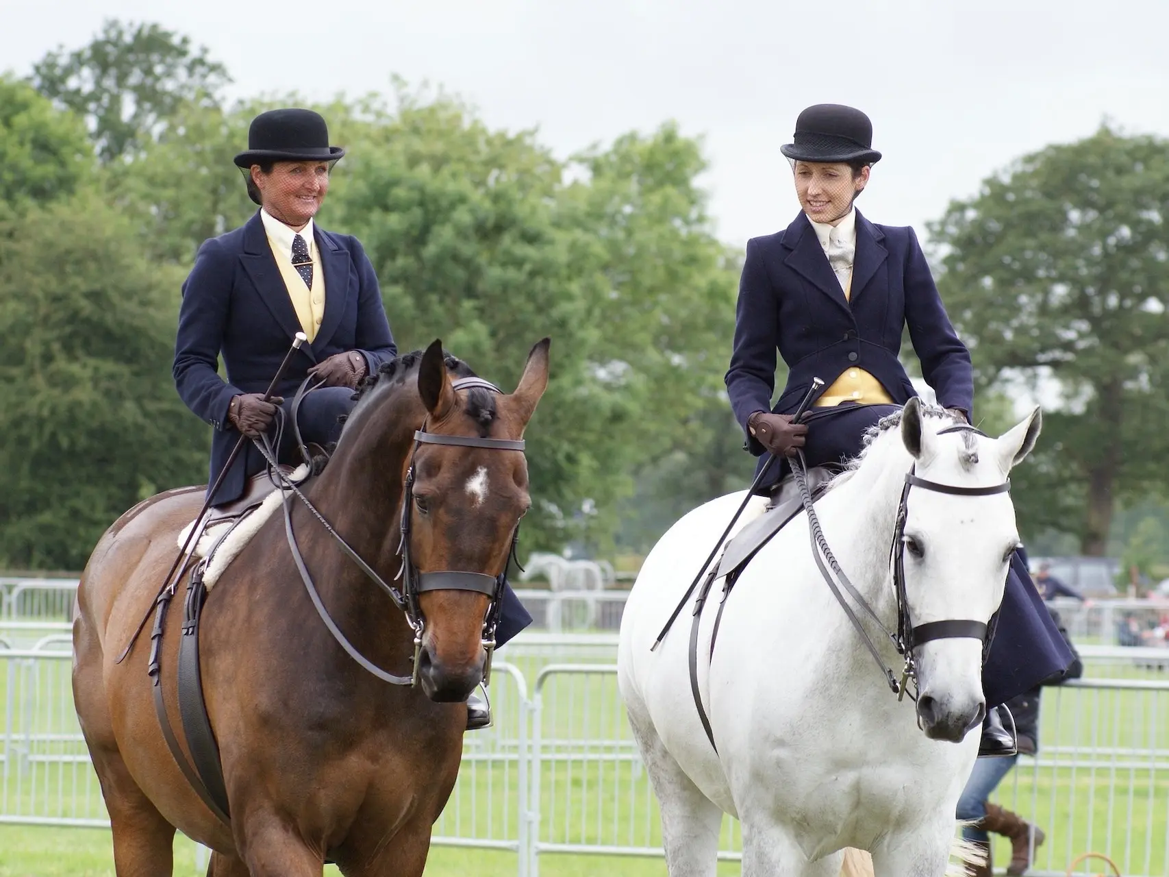 Two women sidesaddle on horses